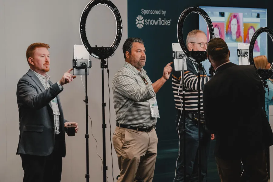 event attendees engaging with ipads with ring lights to take cool ai photo booth pics