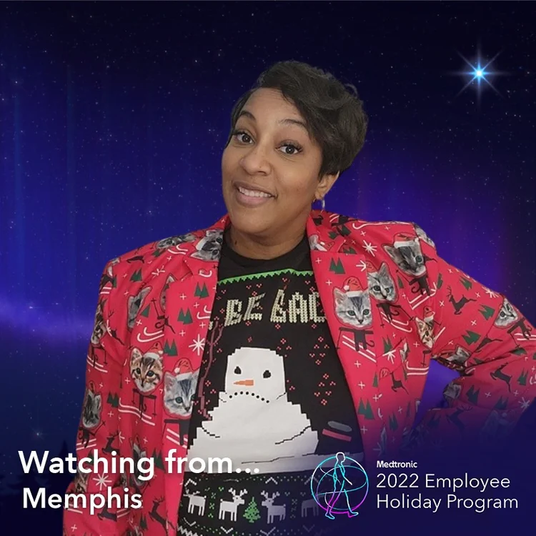 Employee in a holiday sweater in a "Watching from Memphis" frame