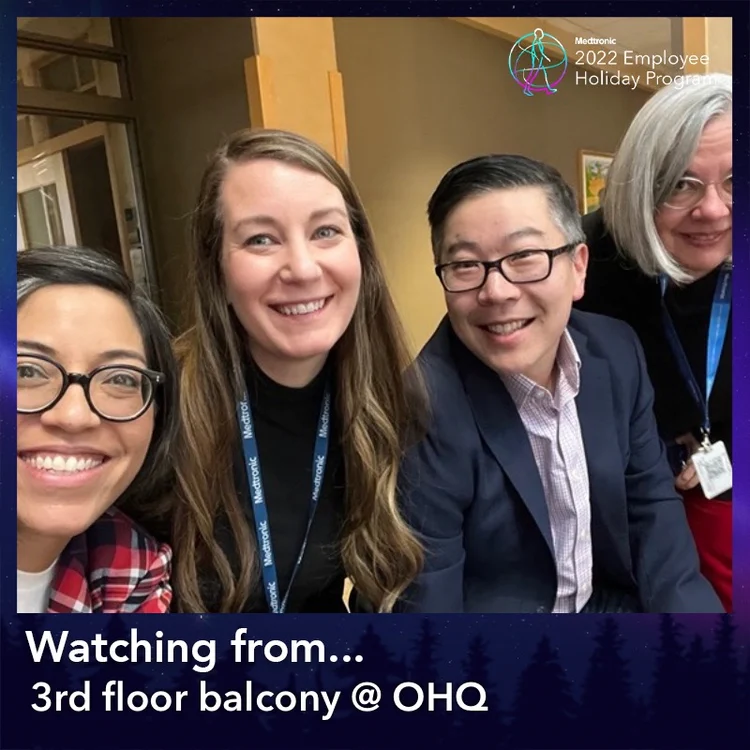 Coworkers taking a selfie in a "3rd floor balcony @ OHQ" frame