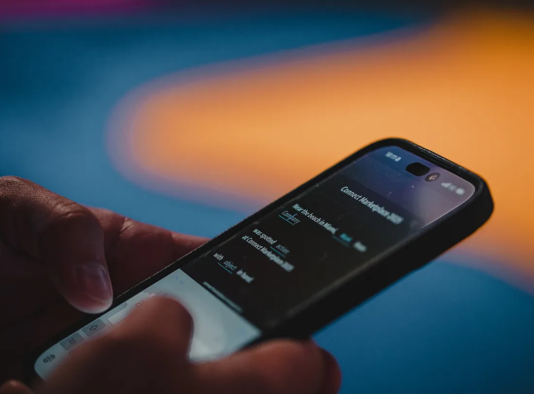 user holding smart phone entering their information into the ai photo booth