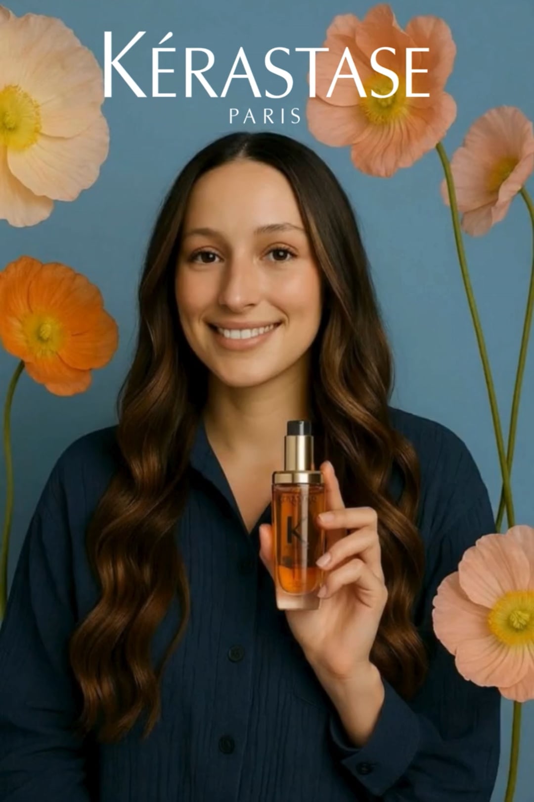 Vertical beauty ad still of a smiling woman holding a hair oil bottle against blue backdrop with poppies