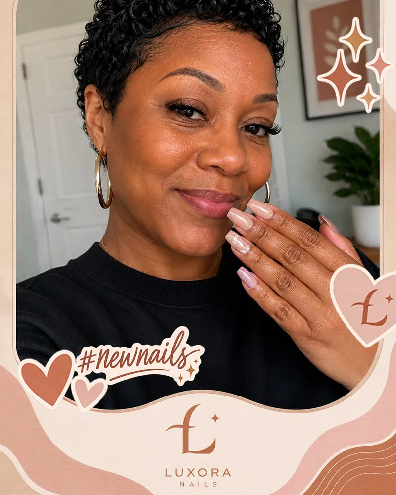 Photo booth snapshot of a guest showing her manicure on a Luxora Nails new nails frame