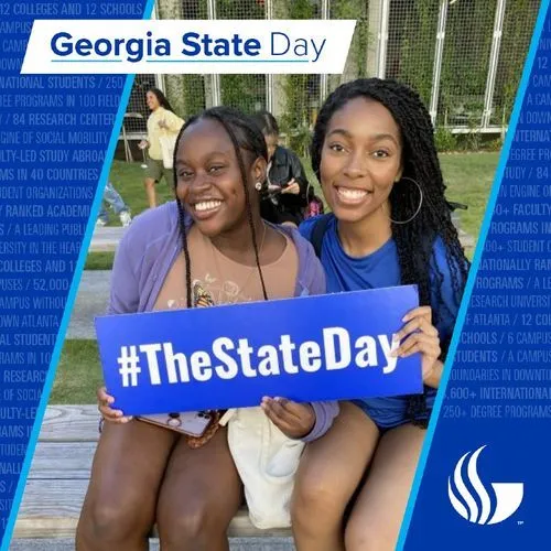 Photo booth snapshot of two students holding a The State Day sign on a Georgia State Day frame