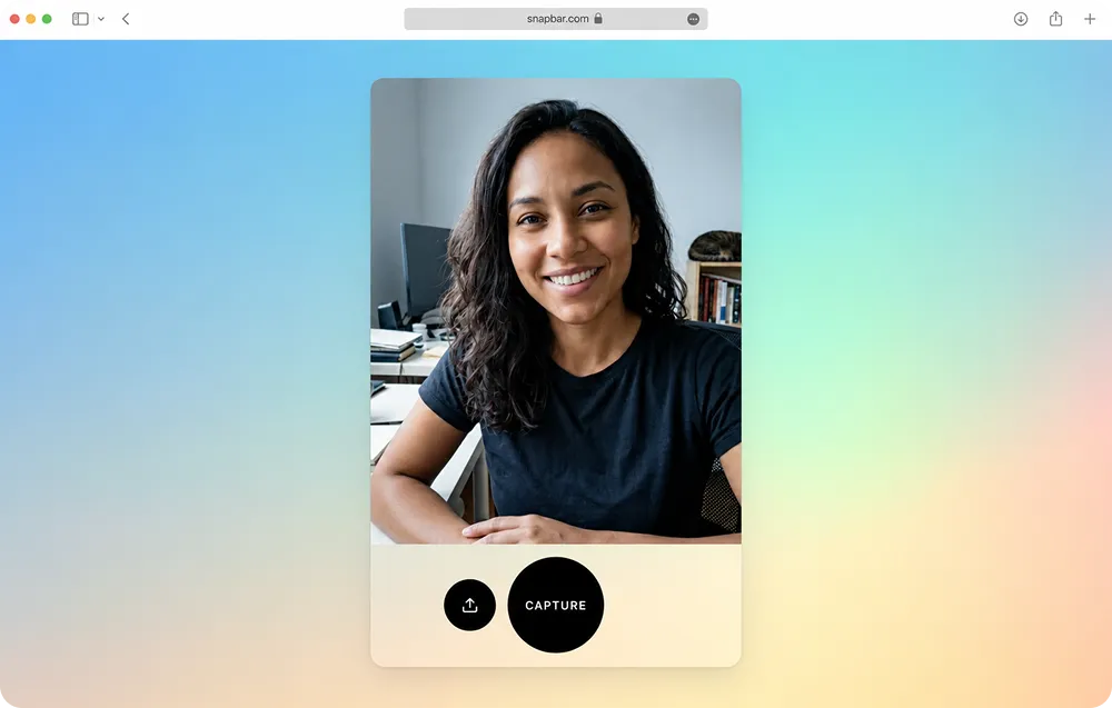 A remote guest at a home desk taking a photo in a virtual photo booth open in a web browser